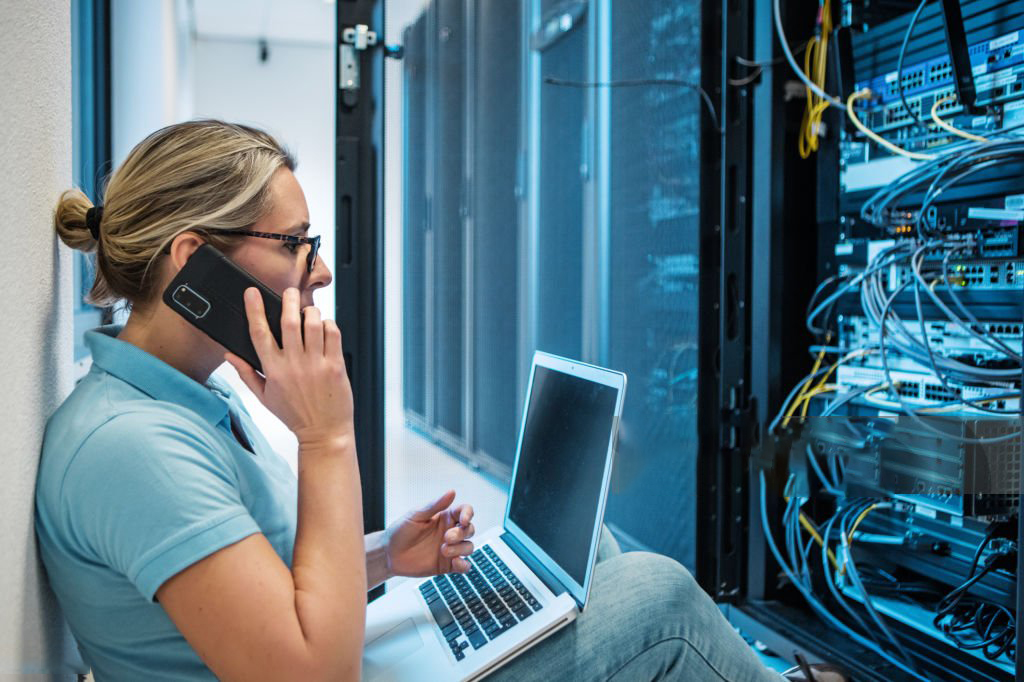 A beautiful blonde female server technician back to the office and server room after lockdown