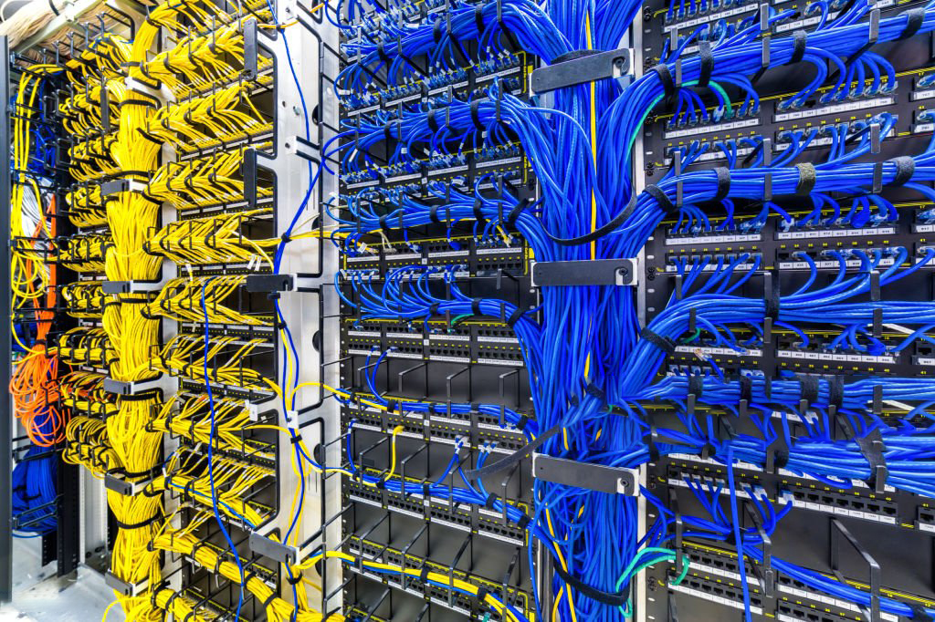 Rack with generic Ethernet cat5e cables, part of a large company data center.